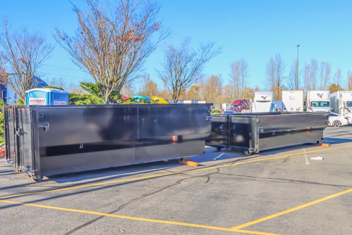 Professional dumpster rental service with roll-off container on residential driveway in Bossier City